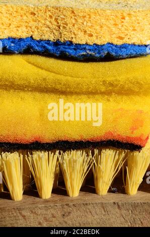 Cleaning supplies in yellow with sponge and brush for house work Stock Photo