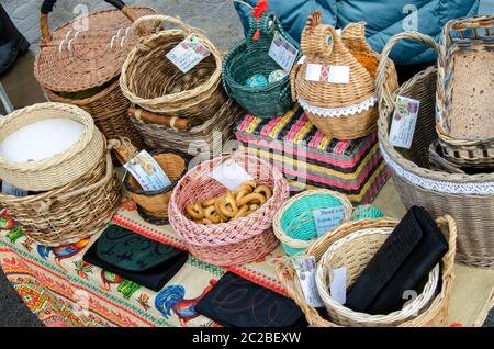 Ceramic plates, hand-painted wooden souvenirs are on the counter at the festive fair. Stock Photo