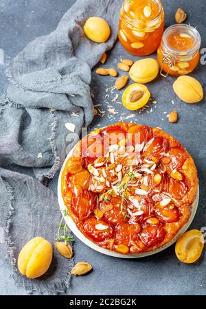 Sliced caramelized tarte tatin pie with apricots. Stock Photo