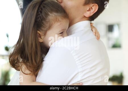 Adorable little daughter embracing father Stock Photo