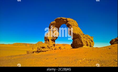 Arch Rock formation aka Arch of Africa or Arch of Algeria with moon at Tamezguida in Tassili nAjjer national park in Algeria Stock Photo