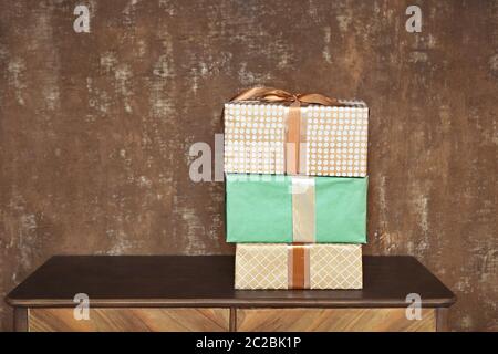 Stack of handcraft gift boxes on wooden board with a natural textured background Stock Photo