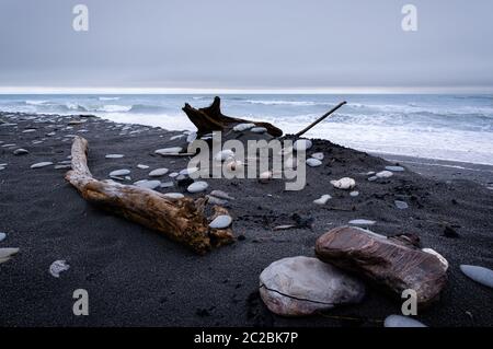 Overcast skies and rough seas at Okarito beach on the west coast of New Zealand's south island. Stock Photo