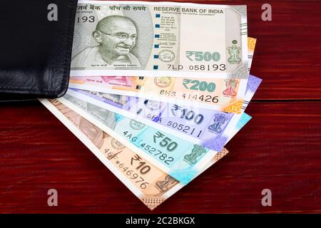 Image of Indian Five Hundred (500) Rupee Cash Note In Brown Color Wallet  Leather Purse On A Wooden Table. Business Finance Economy Concept. Side  Angel View Extreme Close Up With Copy Space