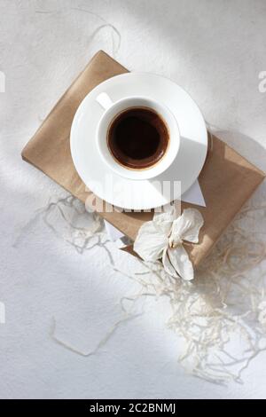 Festive Composition of Cup of Coffee and Present Box on a White Background. Winter Holidays. Stock Photo
