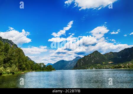 Amazing view landscape on beatiful Lake Idro in Brescia Province, Lombardy, Italy. Scenic small town with traditional houses and clear blue water. Sum Stock Photo