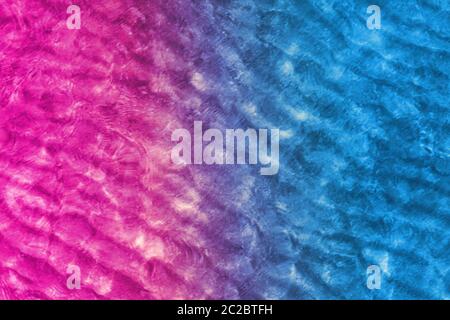Light blue and violet neon background made of sea water or modern creative design. Flat lay. Nature and vacation concept. Stock Photo