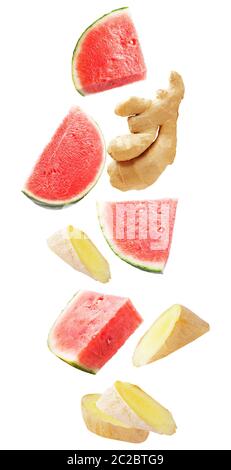 Isolated flying fruit. Falling watermelon fruits and ginger roots isolated on white background with clipping path as package design element and advert Stock Photo