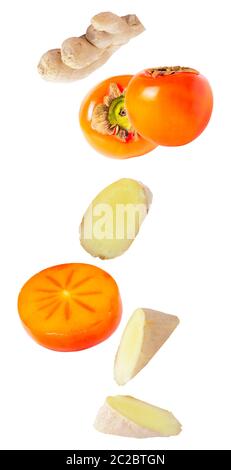 Isolated flying fruit. Falling persimmon with ginger isolated on white background with clipping path as package design element and advertising. depth Stock Photo