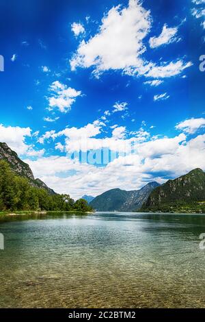 Amazing view landscape on beatiful Lake Idro in Brescia Province, Lombardy, Italy. Scenic small town with traditional houses and clear blue water. Sum Stock Photo