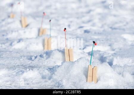 Floats for winter fishing, selective soft focus. Short winter fishing rod with float. Stock Photo