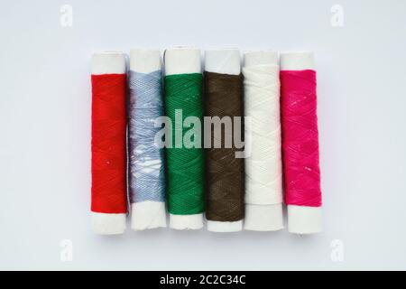 Set of colored sewing threads on a white background Stock Photo