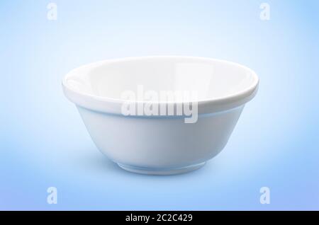 Empty white bowl isolated on blue background, ideal for the presentation of dairy products Stock Photo