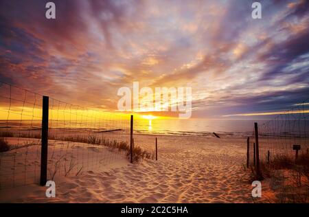 Scenic sunset over Baltic Sea beach with dramatic cloudscape, Poland. Stock Photo