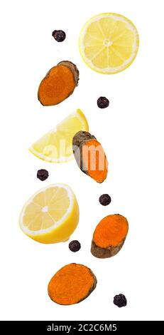 Isolated flying spices. Detox effect of combination with turmeric, lemon and pepper. full depth of field. clipping path as package design element and Stock Photo