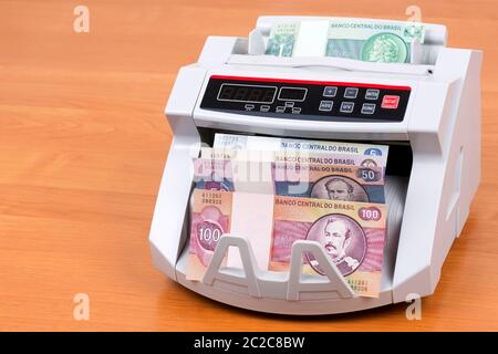 Old Brazilian money in a counting machine Stock Photo