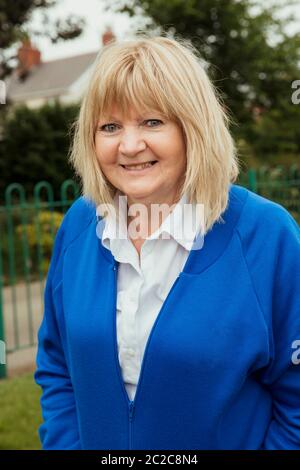 A portrait of a senior woman smiling at a bowling green. Stock Photo