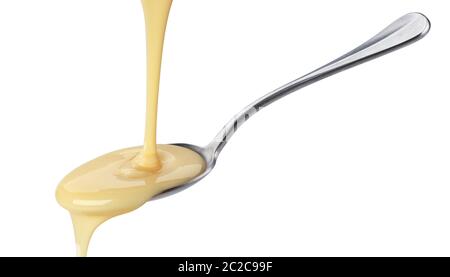 Pouring condensed milk isolated on white background Stock Photo