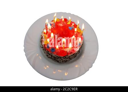 birthday cake with lighted candles on the plate Stock Photo