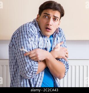 Young repairman contractor repairing heating panel Stock Photo