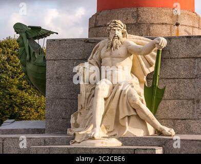 Rostral or victory column male figure representing river god and naiad sea creature on ship prow, The Spit, Vasilyevsky Island, St Petersburg, Russia Stock Photo