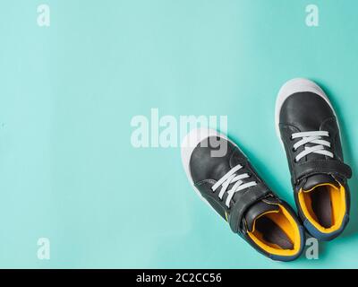 Gray and yellow sneakers on blue background Stock Photo