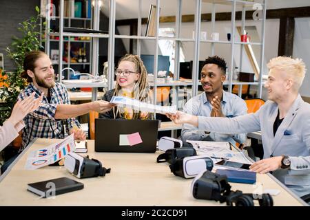 Startup, teamwork, brainstorming, meeting concept. Creative five multiethnic business coworkers sharing ideas while planning joint start up. Two men Stock Photo