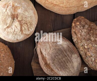 baked various breads on wooden background, top view Stock Photo