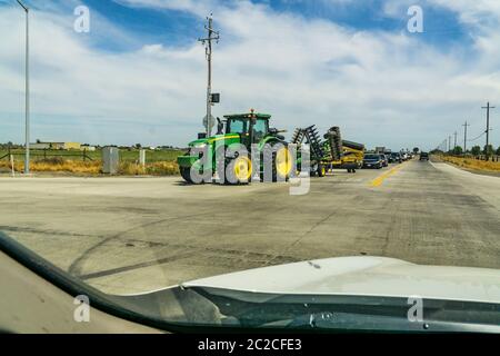 A John Deere model A tractor pulling a plow Stock Photo - Alamy