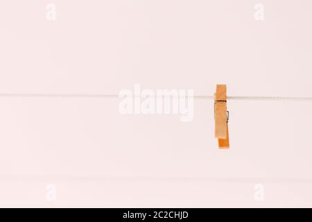 Colored clothespins on a rope on a blurred background Stock Photo
