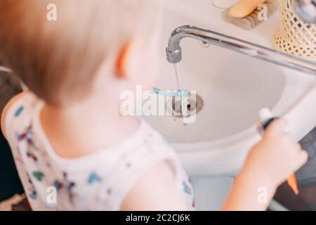 Little child toddler boy brushing his teeth in bathroom Stock Photo