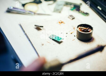 Image of engineer with soldering iron repairing mechanism Stock Photo