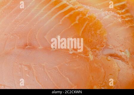 Close-up showing the texture of a slice of smoked salmon. Stock Photo