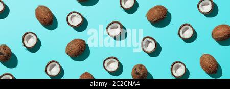 Coconuts half on blue background, banner Stock Photo