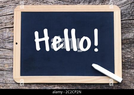 On a blackboard is written with chalk: Hello! Stock Photo