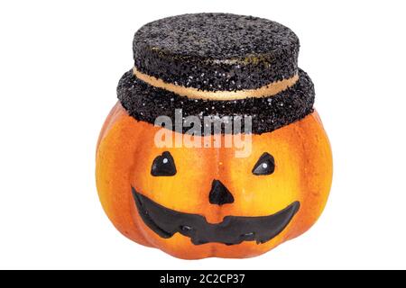 Halloween pumpkin isolated. Close-up of a decoration Halloween pumpkin with black hat made of ceramics isolated on a white background. Macro. Stock Photo