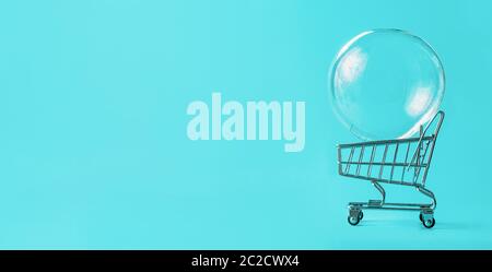 Shopping cart with soap bubble on blue background Stock Photo