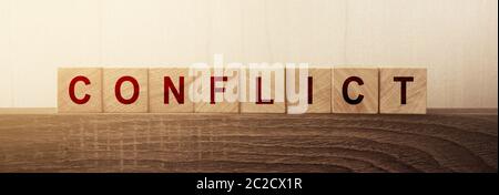 Conflict Word on Wooden Cube. Conflict of interests solution compromise business concept Stock Photo