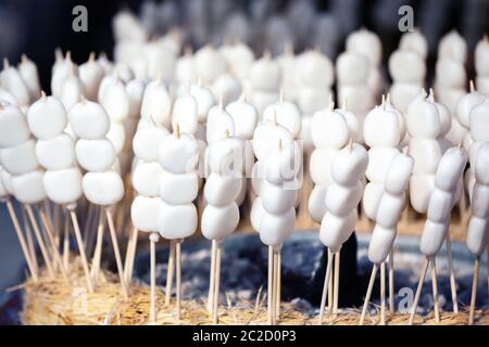 Mochi on a sticks, sweet rice cake dessert, at Nishiki market, Kyoto, Japan Stock Photo