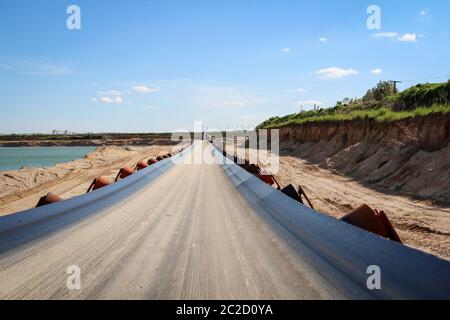 A string of transport belting in a gravel pit for transporting gravel and sand over long distances. Stock Photo