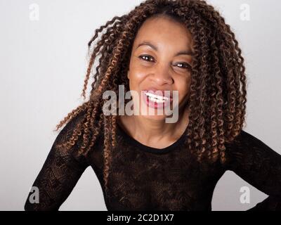 horizontal portrait of a joyful Afro American woman wearing an elegant see through sweater Stock Photo