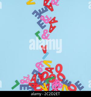 some letters of the colorful alphabet in scattered order on a colored surface Stock Photo