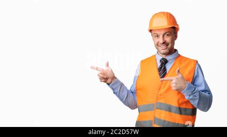 Construction Worker Pointing Fingers Aside Posing On White Background, Panorama Stock Photo