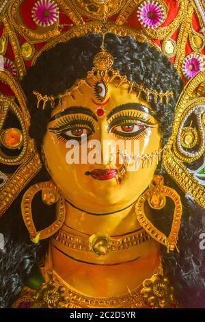 A close up face of Goddess Maa Durga Idol. A symbol of strength and power as per Hinduism. This portrait was taken during Durga Puja celebrations at a Stock Photo