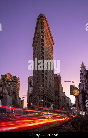 New York City / USA - OCT 17 2018: Crowd and busy traffic on rush hour street in Flatiron Building district during sunset