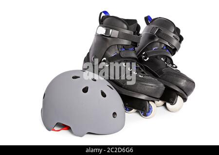 Close up of black aggressive inline skates and a helmet, isolated on white background. Stock Photo