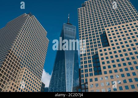 One World Trade Center tower in lower Manhattan against clear blue sky in New York City Stock Photo