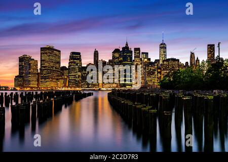 New York City / USA - MAY 28 2015: Lower Manhattan skyline view from Brooklyn Bridge Park waterfront at sunset Stock Photo