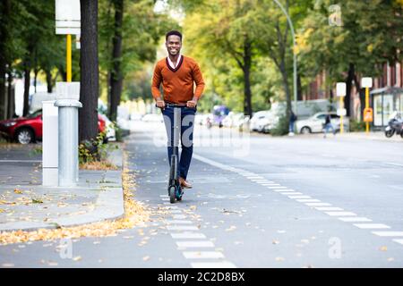 Young African Man Riding An Electric Scooter Stock Photo