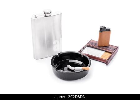 Stainless steel flask, ashtray, some cigarettes, and lighter on a cigarette case, isolated on white background. Stock Photo